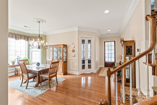 8115 Wilburn Ct, Charlotte, NC 28277 - dining area with stairs, light wood finished floors, a chandelier, crown molding, and recessed lighting
