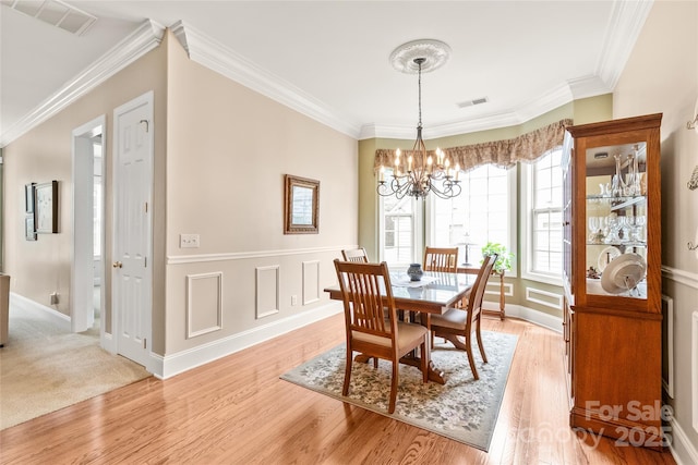 8115 Wilburn Ct, Charlotte, NC 28277 - dining area featuring a chandelier, crown molding, light wood-type flooring, and baseboards