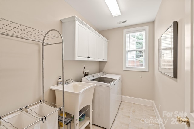 8115 Wilburn Ct, Charlotte, NC 28277 - laundry room with washing machine and dryer, cabinet space, baseboards, and light tile patterned floors