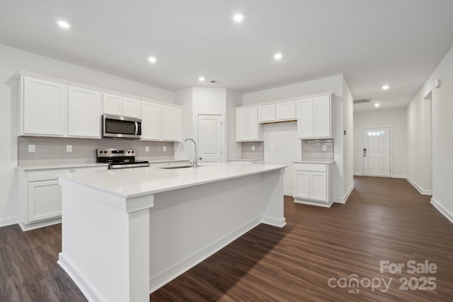 2584 Blue Sky Meadows Dr, Monroe, NC 28110 - kitchen with appliances with stainless steel finishes, tasteful backsplash, white cabinets, and recessed lighting