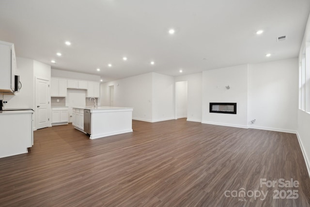 2584 Blue Sky Meadows Dr, Monroe, NC 28110 - unfurnished living room featuring recessed lighting, dark wood-style flooring, and a glass covered fireplace