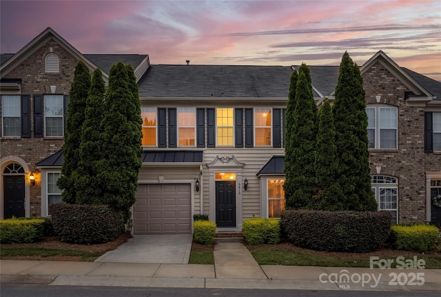 6416 Union Station Ct, Charlotte, NC 28210 - townhome / multi-family property with a garage, a standing seam roof, driveway, and a metal roof