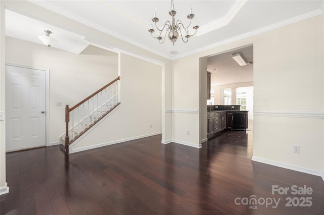 6416 Union Station Ct, Charlotte, NC 28210 - unfurnished living room with dark wood-style floors, stairway, a chandelier, and crown molding