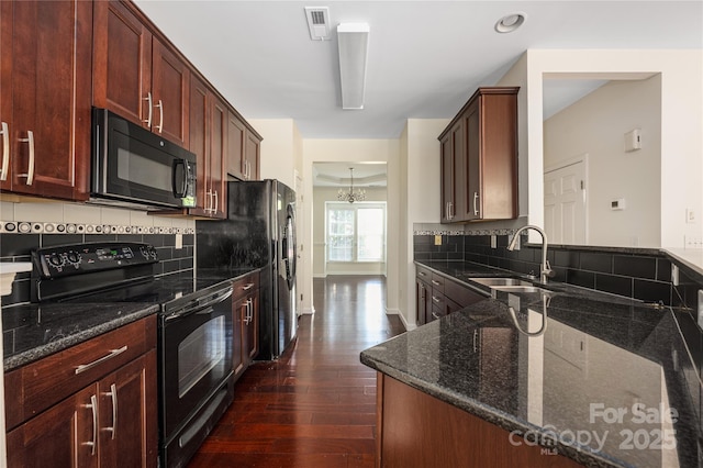 6416 Union Station Ct, Charlotte, NC 28210 - kitchen with black appliances, dark wood finished floors, backsplash, and dark stone countertops