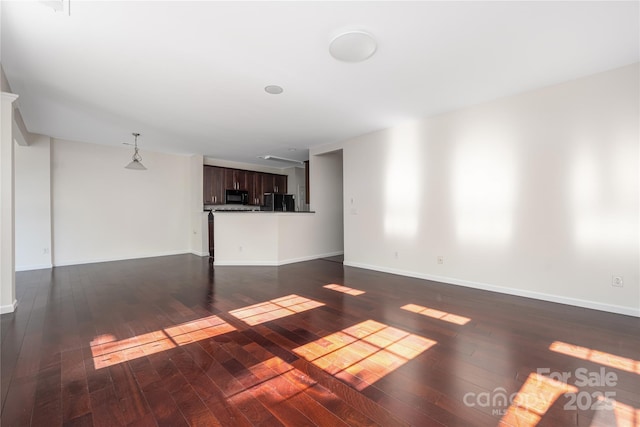 6416 Union Station Ct, Charlotte, NC 28210 - unfurnished living room featuring dark wood finished floors and baseboards