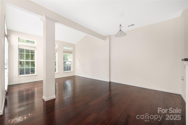 6416 Union Station Ct, Charlotte, NC 28210 - unfurnished living room featuring decorative columns, dark wood finished floors, and vaulted ceiling
