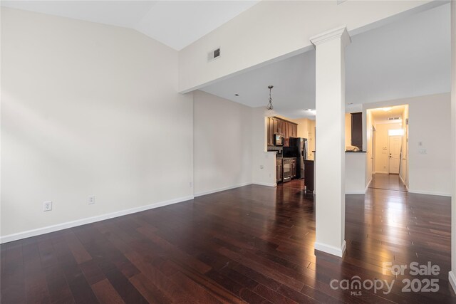 6416 Union Station Ct, Charlotte, NC 28210 - unfurnished living room with lofted ceiling, dark wood-type flooring, and ornate columns