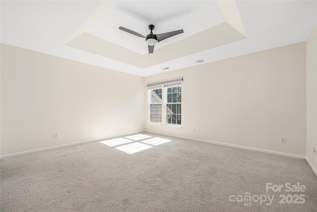 6416 Union Station Ct, Charlotte, NC 28210 - spare room featuring a tray ceiling, a ceiling fan, and carpet