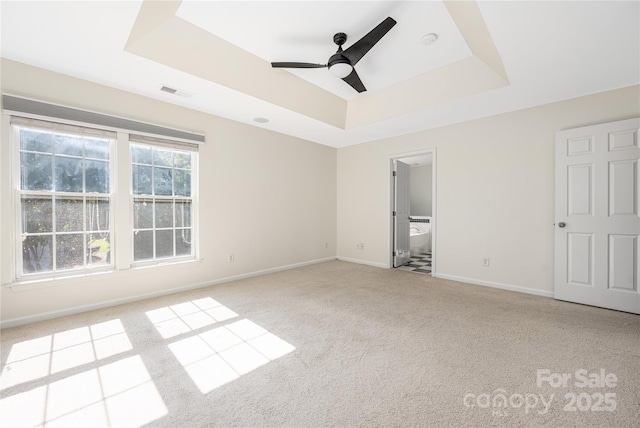 6416 Union Station Ct, Charlotte, NC 28210 - unfurnished bedroom featuring a tray ceiling, carpet, connected bathroom, and ceiling fan