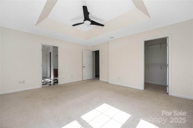 6416 Union Station Ct, Charlotte, NC 28210 - unfurnished bedroom with a tray ceiling, carpet flooring, a spacious closet, a ceiling fan, and ensuite bath