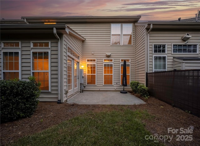 6416 Union Station Ct, Charlotte, NC 28210 - back of property at dusk featuring a patio area
