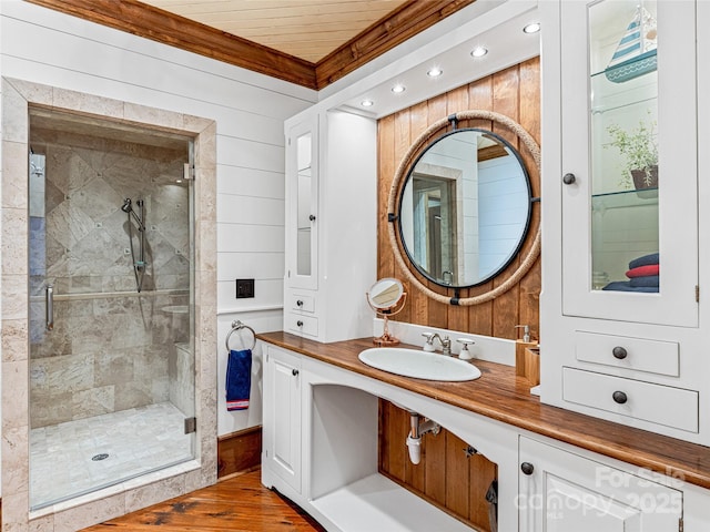 41 Chimney Pt, Lake Toxaway, NC 28747 - full bath featuring wood finished floors, a stall shower, vanity, recessed lighting, and crown molding