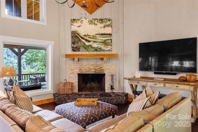 75 Indigo Bunting Ct, Tuckasegee, NC 28783 - living area featuring a towering ceiling, wood finished floors, and a stone fireplace