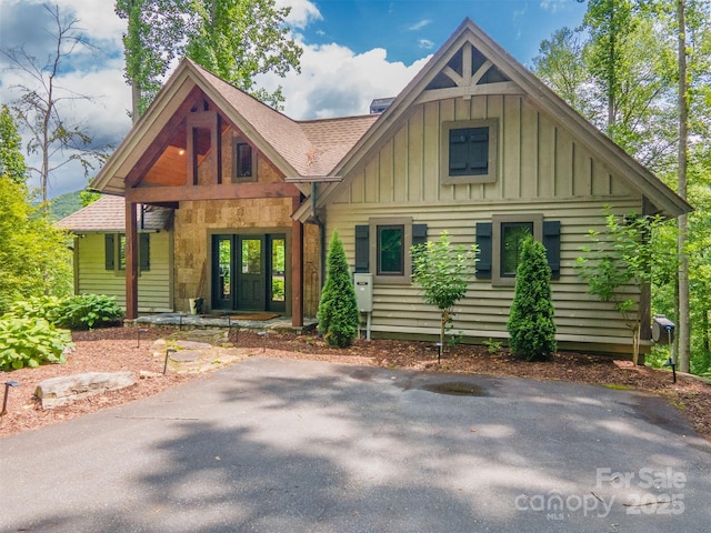 75 Indigo Bunting Ct, Tuckasegee, NC 28783 - view of front of house with board and batten siding, roof with shingles, and covered porch
