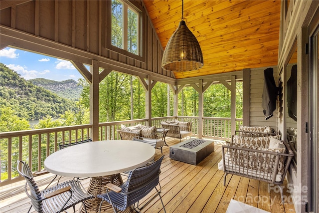 75 Indigo Bunting Ct, Tuckasegee, NC 28783 - wooden deck with an outdoor living space with a fire pit, a mountain view, and a view of trees