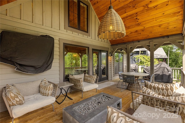 75 Indigo Bunting Ct, Tuckasegee, NC 28783 - sunroom featuring vaulted ceiling, a fire pit, healthy amount of natural light, outdoor dining space, and french doors