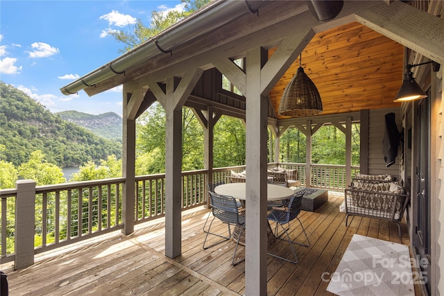 75 Indigo Bunting Ct, Tuckasegee, NC 28783 - wooden terrace with a view of trees, a mountain view, and outdoor dining space