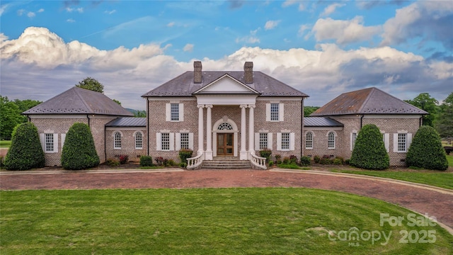 1100 Glen Oaks Dr, Hamptonville, NC 27020 - greek revival inspired property with a chimney, a front yard, and brick siding