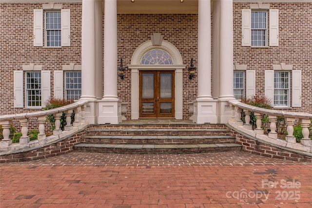 1100 Glen Oaks Dr, Hamptonville, NC 27020 - property entrance featuring french doors, brick siding, and covered porch