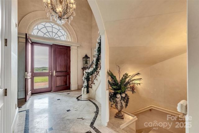 1100 Glen Oaks Dr, Hamptonville, NC 27020 - foyer entrance with inlaid floor details, a chandelier, marble finish floors, and stairway