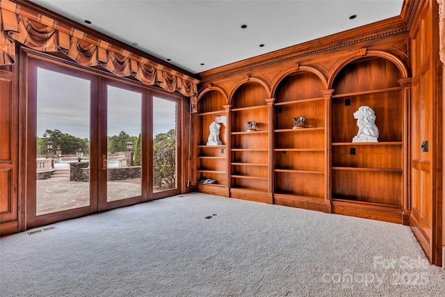1100 Glen Oaks Dr, Hamptonville, NC 27020 - carpeted empty room featuring built in shelves and crown molding