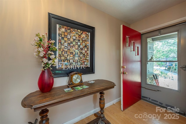 52 Oakhurst Rd, Arden, NC 28704 - doorway to outside with light wood-style flooring, baseboards, and a baseboard radiator