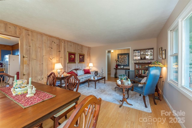 52 Oakhurst Rd, Arden, NC 28704 - dining room featuring light wood-style flooring, wood walls, and baseboards