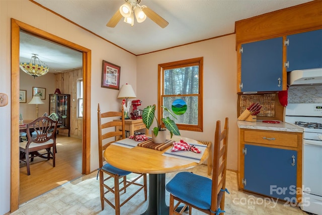 52 Oakhurst Rd, Arden, NC 28704 - dining area featuring ornamental molding, light wood finished floors, a ceiling fan, and wooden walls