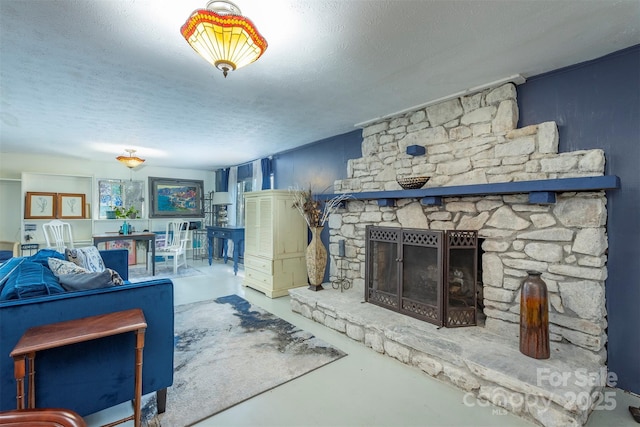 52 Oakhurst Rd, Arden, NC 28704 - living area with a textured ceiling, concrete flooring, and a fireplace