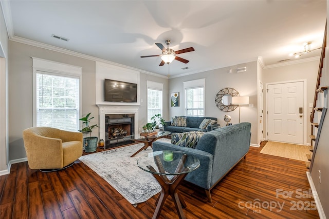 1206 Craig Ave, Lancaster, SC 29720 - living room featuring dark wood-style flooring, a ceiling fan, ornamental molding, a fireplace, and baseboards
