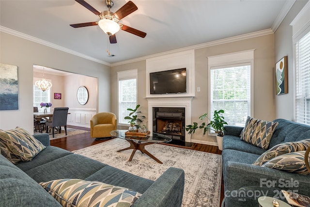 1206 Craig Ave, Lancaster, SC 29720 - living room with crown molding, a chandelier, wood finished floors, a fireplace, and ceiling fan