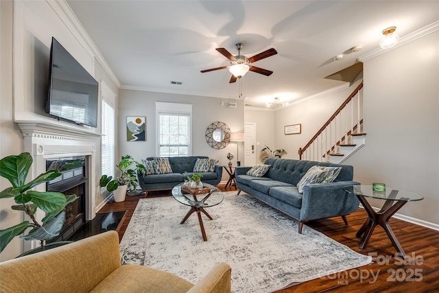 1206 Craig Ave, Lancaster, SC 29720 - living area featuring stairway, dark wood-type flooring, a ceiling fan, crown molding, and a fireplace