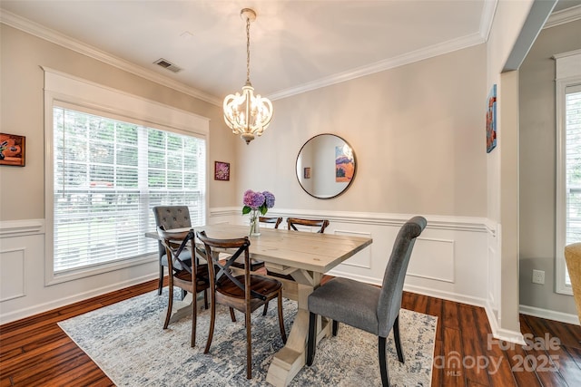 1206 Craig Ave, Lancaster, SC 29720 - dining room featuring a chandelier, ornamental molding, healthy amount of natural light, dark wood-style flooring, and a wainscoted wall