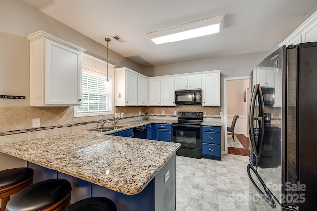 1206 Craig Ave, Lancaster, SC 29720 - kitchen featuring black appliances, blue cabinets, a sink, a peninsula, and white cabinets