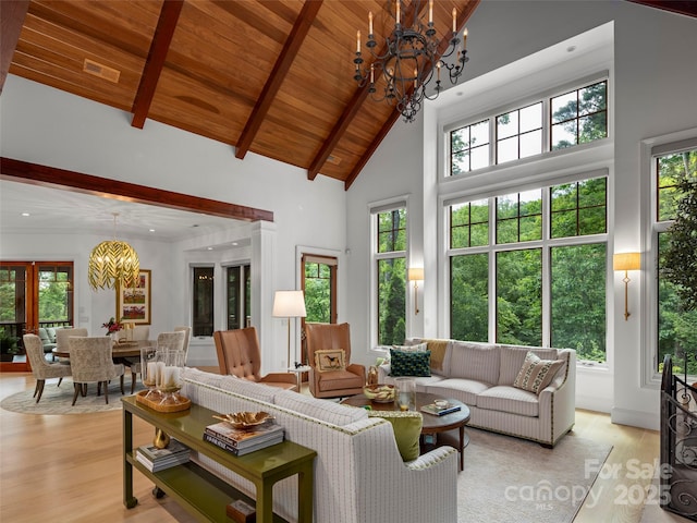 24 Deep Creek Trl, Arden, NC 28704 - living room featuring a chandelier, light wood finished floors, wooden ceiling with exposed beams, high vaulted ceiling, and plenty of natural light