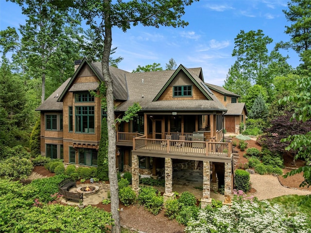 24 Deep Creek Trl, Arden, NC 28704 - back of house with an outdoor fire pit, roof with shingles, a patio area, a wooden deck, and stone siding