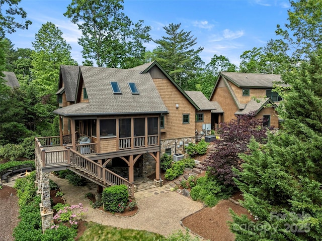 24 Deep Creek Trl, Arden, NC 28704 - back of house with a sunroom, roof with shingles, stone siding, stairs, and a deck