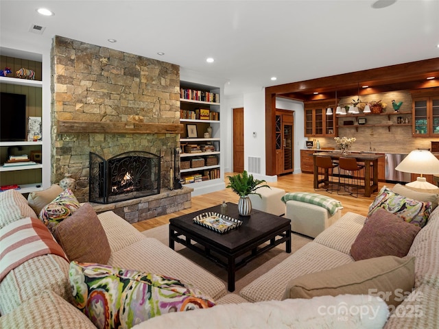 24 Deep Creek Trl, Arden, NC 28704 - living area with a stone fireplace, light wood-type flooring, built in features, and recessed lighting