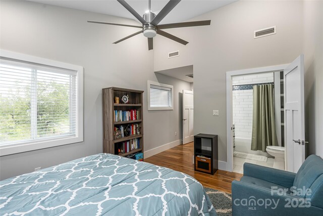 307 Hazel Mill Rd, Asheville, NC 28806 - bedroom featuring high vaulted ceiling, wood finished floors, baseboards, ensuite bath, and ceiling fan