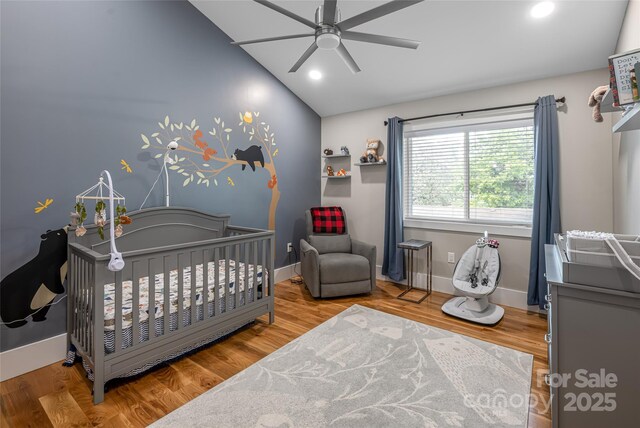 307 Hazel Mill Rd, Asheville, NC 28806 - bedroom featuring lofted ceiling, a nursery area, baseboards, wood finished floors, and recessed lighting