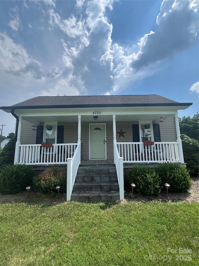 8720 Lee St, Mount Pleasant, NC 28124 - bungalow-style home featuring covered porch, a front yard, and a shingled roof