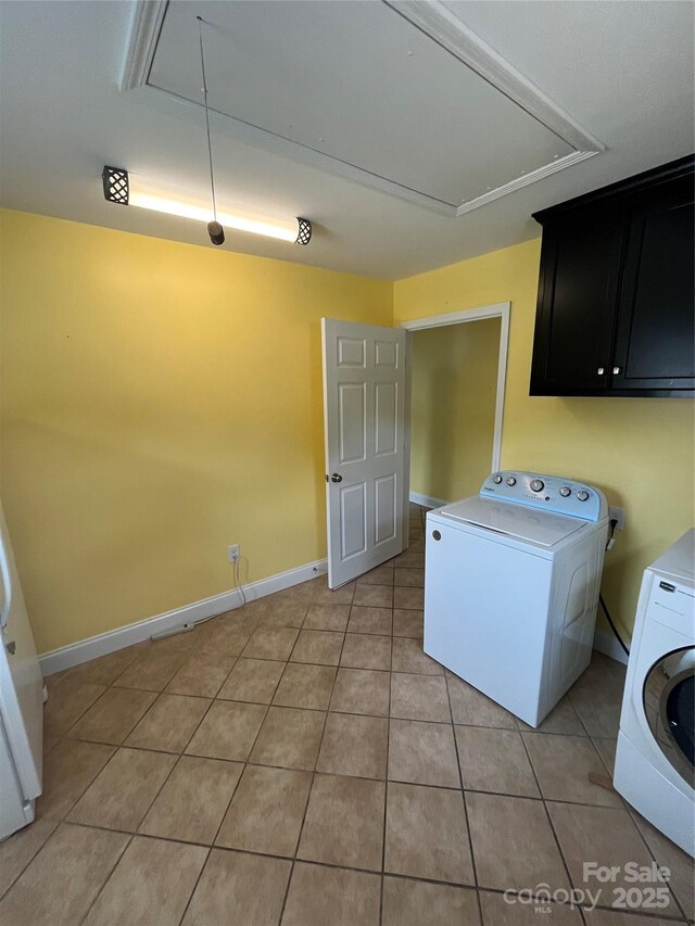 8720 Lee St, Mount Pleasant, NC 28124 - washroom featuring attic access, cabinet space, washer and clothes dryer, and light tile patterned flooring