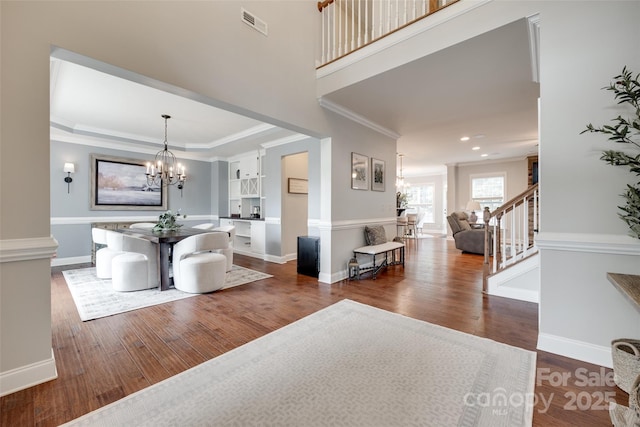 645 Brookhaven Dr, Fort Mill, SC 29708 - dining room featuring a chandelier, dark wood-style flooring, crown molding, stairway, and baseboards