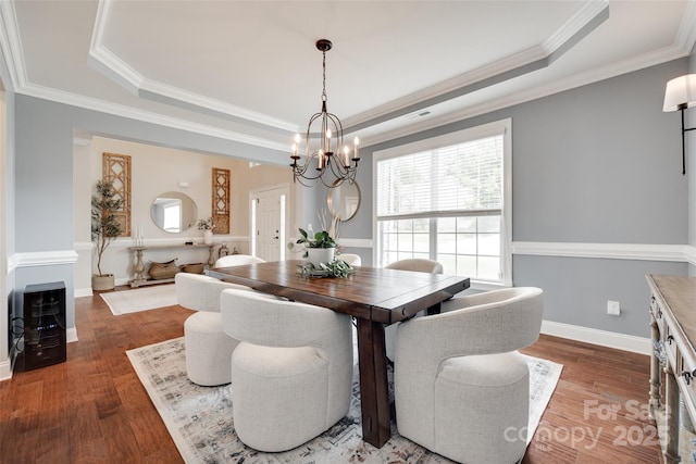 645 Brookhaven Dr, Fort Mill, SC 29708 - dining room with a tray ceiling, a chandelier, wood finished floors, and ornamental molding