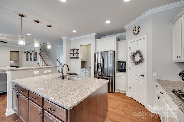 645 Brookhaven Dr, Fort Mill, SC 29708 - kitchen featuring appliances with stainless steel finishes, a sink, a center island with sink, crown molding, and light wood-style floors