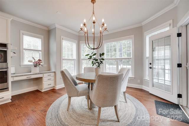 645 Brookhaven Dr, Fort Mill, SC 29708 - dining room with a chandelier, wood finished floors, crown molding, and baseboards