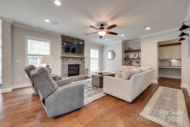 645 Brookhaven Dr, Fort Mill, SC 29708 - living room featuring wood finished floors, ceiling fan, a fireplace, recessed lighting, and crown molding