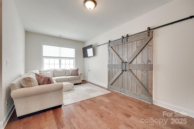 645 Brookhaven Dr, Fort Mill, SC 29708 - living area featuring a barn door, wood finished floors, and baseboards