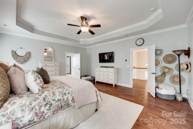645 Brookhaven Dr, Fort Mill, SC 29708 - bedroom featuring a raised ceiling, wood finished floors, ornamental molding, baseboards, and a ceiling fan