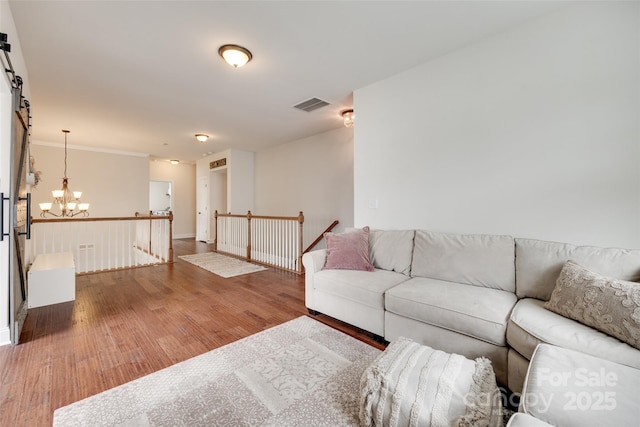 645 Brookhaven Dr, Fort Mill, SC 29708 - living area featuring a chandelier, wood finished floors, and baseboards